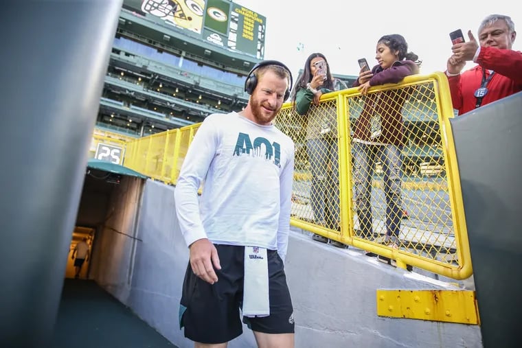 Eagles quarterback Carson Wentz walks out the tunnel and on to Lambeau Field to warm up before the Sept. 26, 2019 game against the Packers.