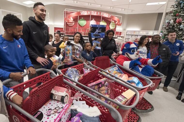 Sixers star rookie Ben Simmons poses for a photo with the four families he treated to a $1,000 (each) Christmas shopping spree at the Target on Monument Road December 14, 2017. The families were from the Unity in the Community organization in South Philadelphia.