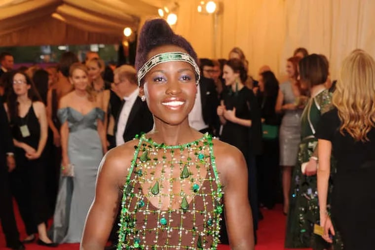 At Monday's Met Gala, Lupita Nyong'o rocked the boat in her brown Prada sheath under a floor-length kelly-green gown of netting and feathers.