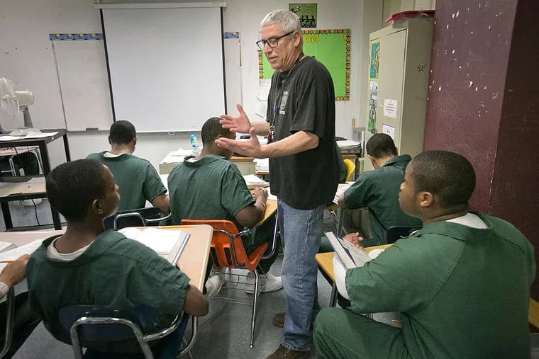 Social Studies teacher Steve DiGiovanni works with students in his classroom at Pennypack House School, in the Philadelphia Industrial Correctional Center.