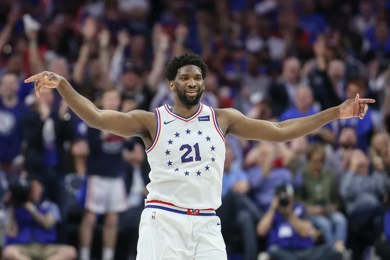 Sixers' Joel Embiid celebrates against the Raptors during the fourth quarter of Game 3.