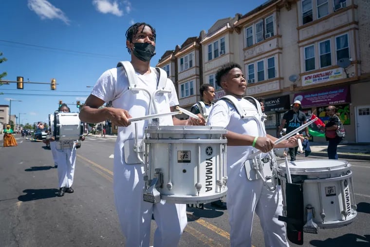 Members of the Enon Tabernacle Baptist Church Trinity Drumline and Drill Team under Senior Pastor Rev. Dr. Alyn E. Waller, participate in the Juneteenth parade Sunday on 52nd Street toward Malcolm X Memorial Park. The parade culminated at the park with a daylong street festival and marketplace.