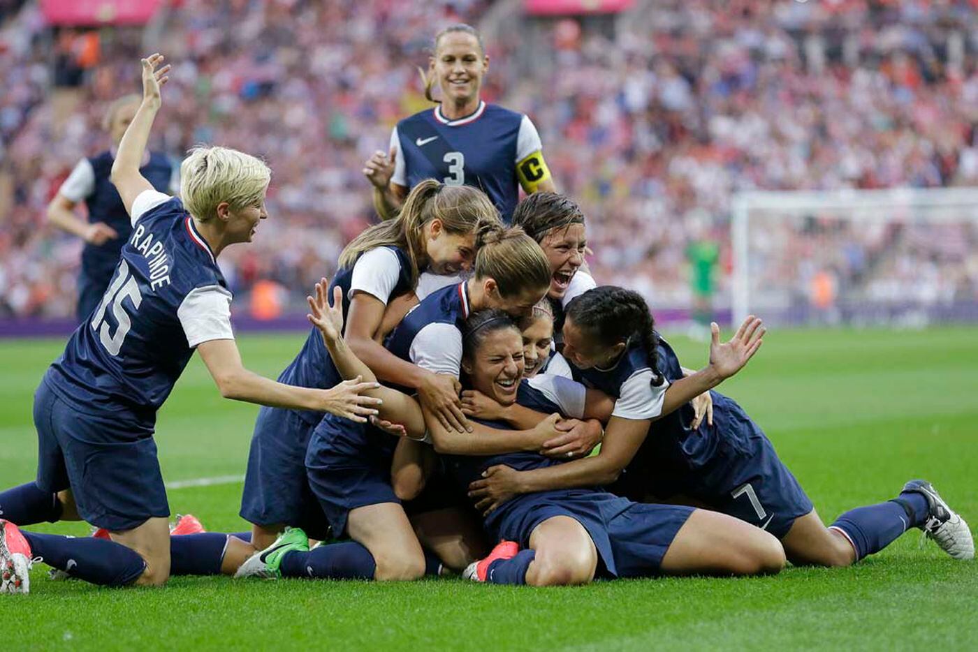 Carli Lloyd was mobbed by teammates after scoring against Japan in the 2012 Olympics gold medal game.