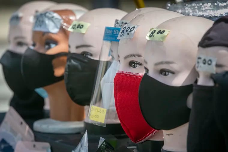An assortment of face masks line a vendor's table along North Fifth Street at Lindley Street in Philadelphia in May. Jay Lopez (not shown), the vendor, switched his product line to fill the need for people looking for masks during the COVID-19 pandemic.