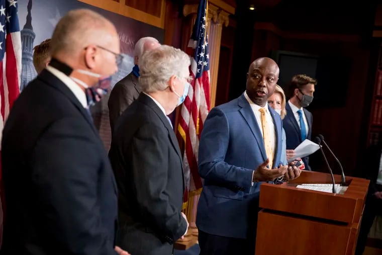 Sen. Tim Scott, R-S.C., accompanied by Senate Majority Leader Mitch McConnell of Ky., second from left, and others, speaks at a news conference to announce a Republican police reform bill on Capitol Hill on Wednesday.