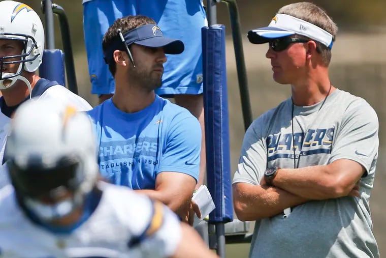 San Diego Chargers coach Mike McCoy, right, talks with new quarterback coach, Nick Sirianni, as the watch drills during an organized team activity for the NFL football team Monday, June 9, 2014, in San Diego. (AP Photo/Lenny Ignelzi)