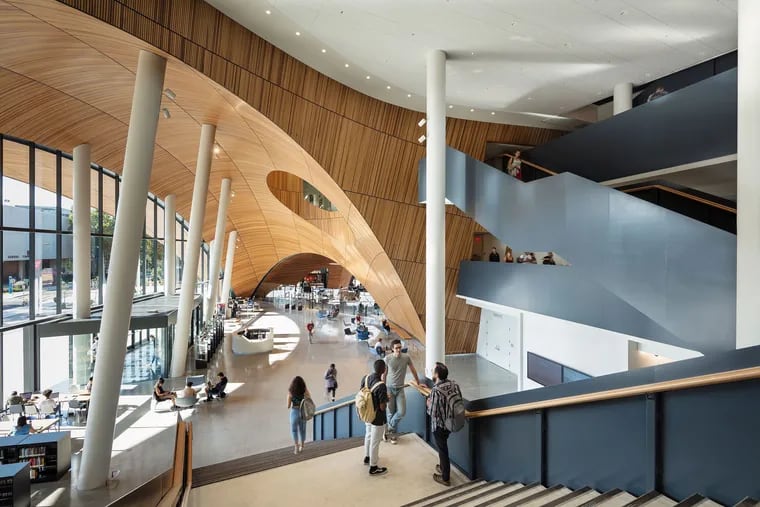 Temple University's new Charles Library was designed by Snohetta. The cedar-clad ceiling arcs over the lobby like an ocean wave.