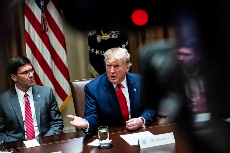 President Donald Trump, flanked by Secretary of Defense Mark Esper, speaks during a meeting with senior military leaders in October 2019.