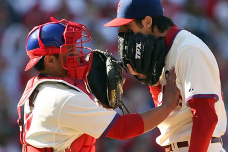 Phillies catcher Carlos Ruiz tries to calm down pitcher Cole Hamels in the third inning of NLDS Game 2 against the Rockies on Thursday at Citizens Bank Park. The Rockies won, 5-4, to even the series at 1-1. (Yong Kim / Staff Photographer)