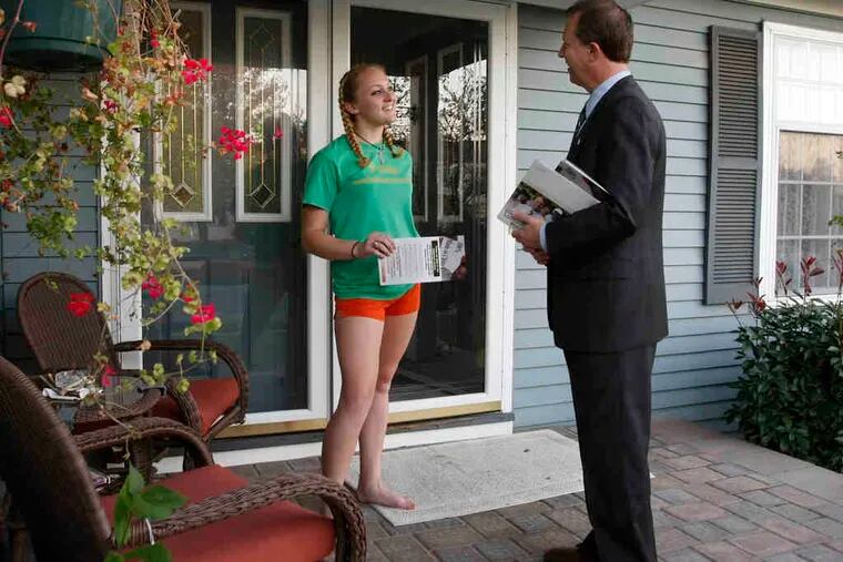 In Evesham, 19-year-old Sylvia Martin receives campaign information from U.S. Rep. John Adler. Opponent Jon Runyan also planned to spend time this weekend with potential voters in battleground areas of the district.
