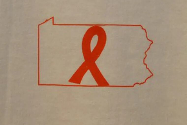 On the front , an orange ribbon and outline of Pennsylvania. The back has the word &quot;United&quot; and college logo.