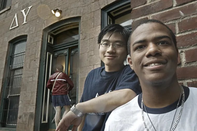 Steven Vaughn-Lewis (right) outside the Delta Upsilon house at the University of Pennsylvania with best friend and fraternity brother Jin Guan. They are planning a trip to China to attend a wedding. (David M. Warren / Staff Photographer)