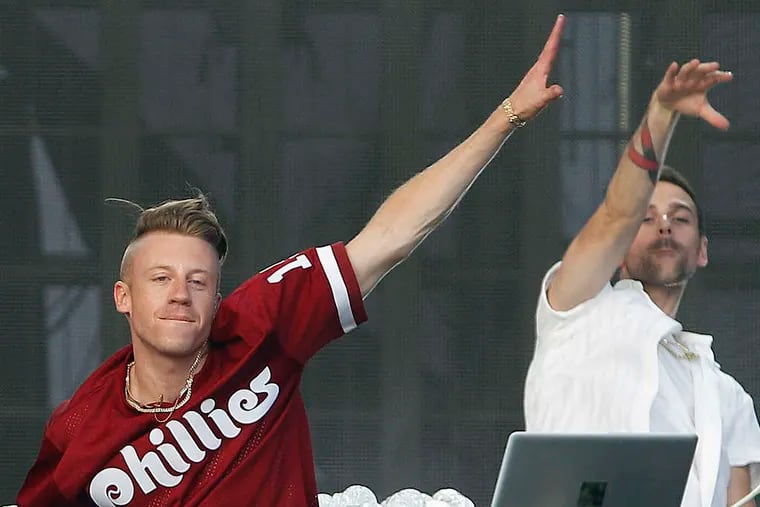 Macklemore, who performed with Ryan Lewis, right, at the 2013 Budweiser Made in America festival on the Parkway, struggled with the stresses of success last year, but his fiancee helped get him back on track.
