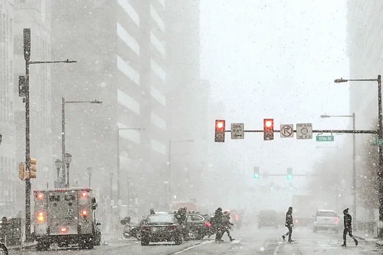 Pedestrians cross at 17th and JFK in Center City during a snow squall in January. Not much more snow fell all winter around here. Could this be a repeat?
