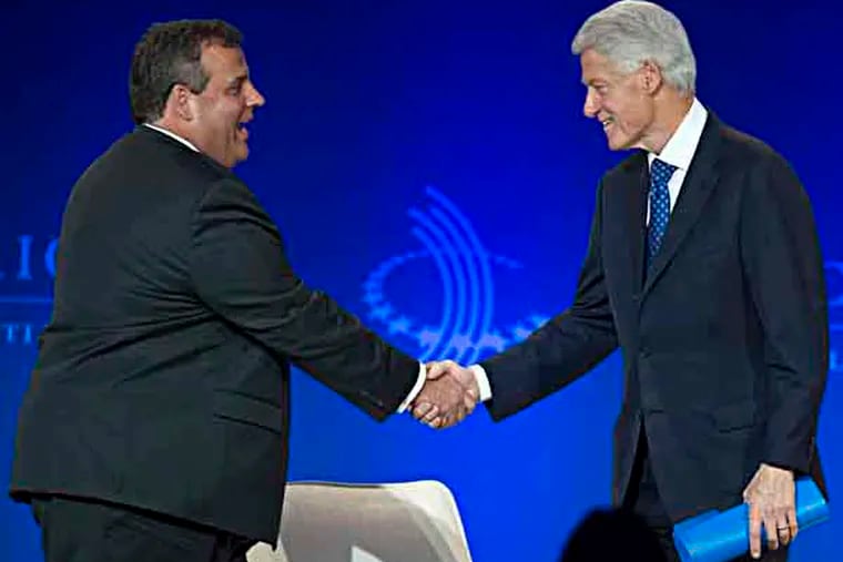Former President Bill Clinton, right, shakes New Jersey Gov. Chris Christie's hand as he arrives on stage during the Clinton Global Initiative (CGI) Meeting in Chicago, Friday, June 14, 2013. Clinton and Christie spoke during a closing session titled "Cooperation and Collaboration: A Conversation on Leadership." (AP Photo/Scott Eisen)