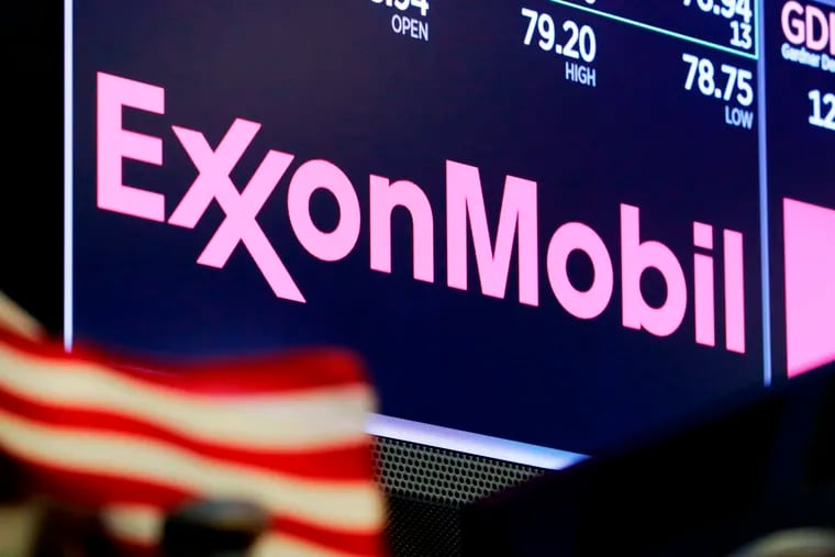 In this April 2018 photo, the logo for ExxonMobil appears above a trading post on the floor of the New York Stock Exchange.