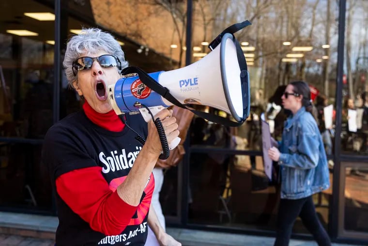 Sherry Wolf, Senior Organizer with AAUP-AFT Rutgers, leads chants as people march and strike outside the Cook Campus Center in New Brunswick, N.J., on Wednesday, March 29, 2023.