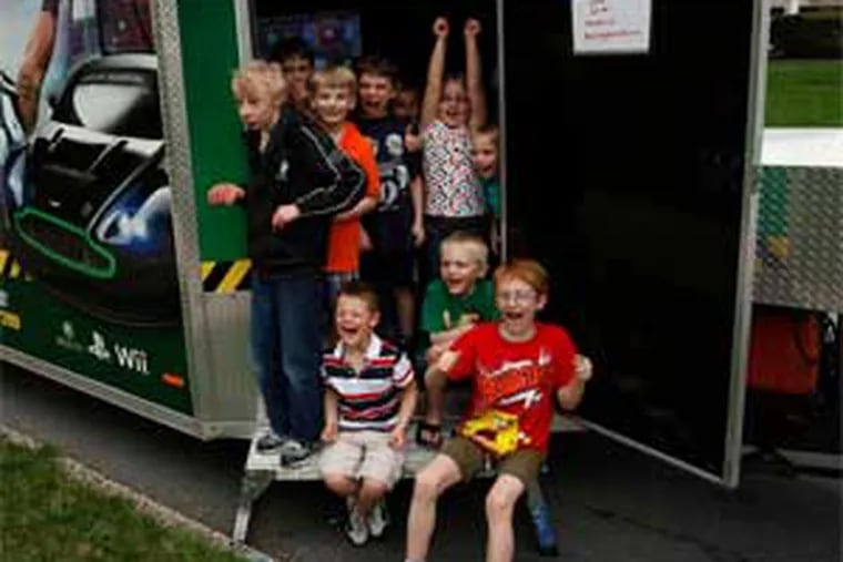 Rolling Game Station, a 32-foot trailer loaded with video games, went to Zachary Jordan's house in Douglassville for his eighth-birthday party. It is one of at least five games on wheels operations in the area. (Michael S. Wirtz / Staff Photographer)