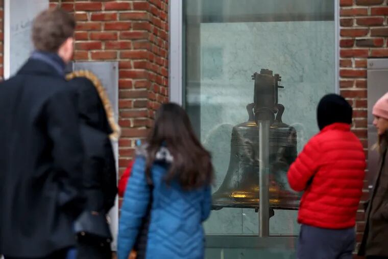 Tourists look at the Liberty Bell in Philadelphia from outside due to the landmark's closure on Saturday, Dec. 22, 2018. (Philly.com/TNS)