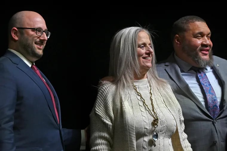Seth Bluestein (from left), Lisa Deeley, and Omar Sabir after they are sworn in as city commissioners on Jan. 2 on the stage of the Met Philadelphia on North Broad Street.