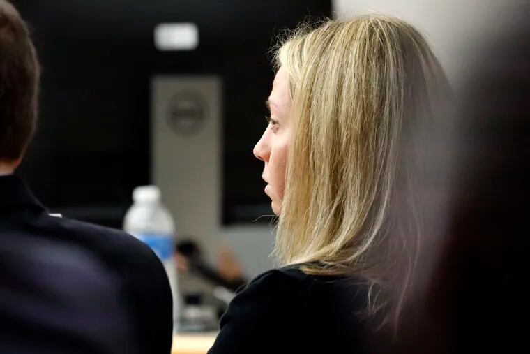 Fired Dallas police officer Amber Guyger listens as friends, family and coworkers speak in her defense during the sentencing phase of her murder trial, Wednesday, Oct. 2, 2019, in Dallas.  Guyger, who said she fatally shot her unarmed, black neighbor Botham Jean after mistaking his apartment for her own, was found guilty of murder the day before.