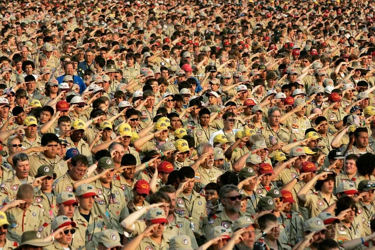 In this file photo, Boy Scouts salute as they recite the Pledge of Allegiance during the Boy Scout Jamboree in Bowling Green, Va.