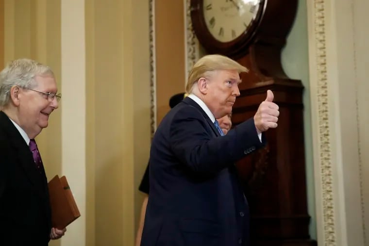 President Donald Trump gestures as he arrives to speak with lawmakers, including Senate Majority Leader Mitch McConnell (R-Ky.) during a policy luncheon last month.