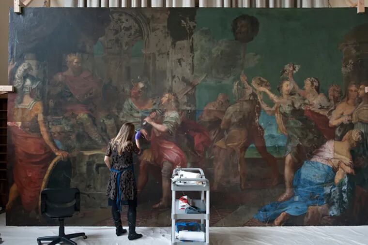 Kristin deGhetaldi, a conservator from the University of Delaware, works on restoring the 17th century deCortona painting at Villanova. (RON TARVER/Staff Photographer)
