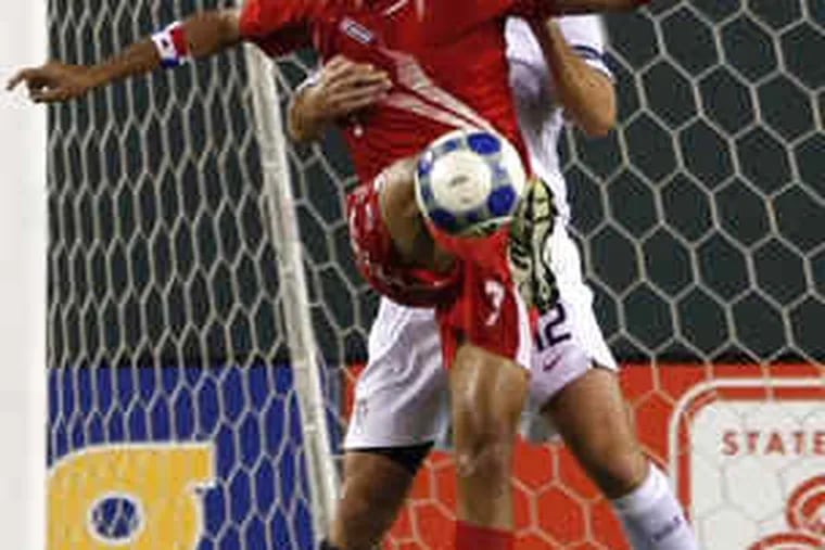 U.S.A.'s Jimmy Conrad (behind) tries to stop Panama's Blas Perez in Gold Cup quarterfinals at the Linc.