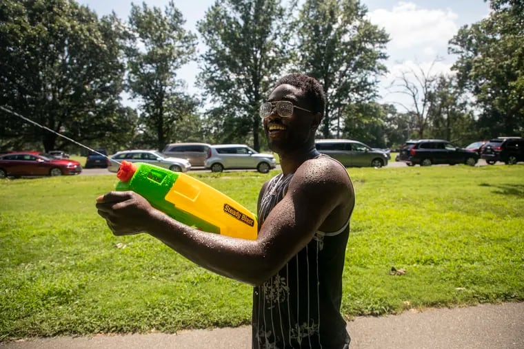 Gabriel Nyantakyi, 36, of West Philadelphia, Pa., joins in on the water fight with families and friends who came out to participate in the Water Fight Philly event at West Fairmount Park on Saturday, July 20, 2019. Nyantakyi is is showing a way for kids to have fun and redefine what a gun is. Nyantakyi is a part of the organization Waterarms Over Firearms to show people there is something to have fun and a peaceful alternative.