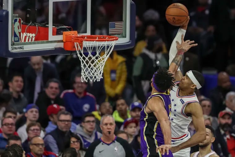 Sixers forward Tobias Harris dunks over the Lakers' JaVale McGee in the first quarter on Sunday.
