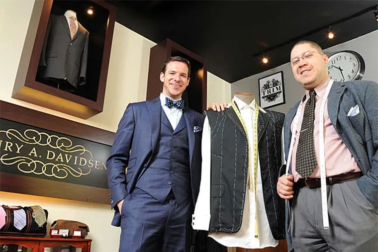 Brian Lipstein (left), owner of Henry A. Davidsen Master Tailors and Image Consultants, and master tailor Jay Tidwell. With the few skilled cutters, patternmakers, and sewers here in high demand, the labor-intensive suits mean a pricey process. (Clem Murray/Staff Photographer)