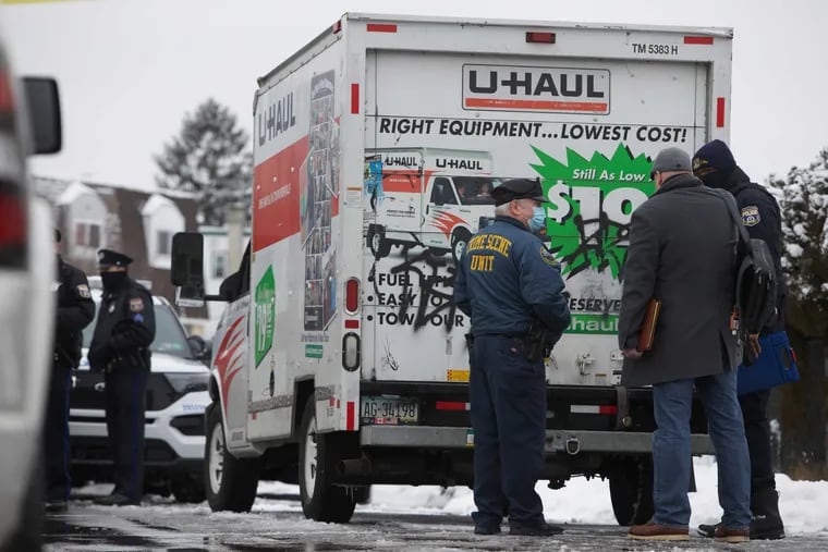 Philadelphia police investigate a body found inside a trash bag in the back of a U-Haul truck.