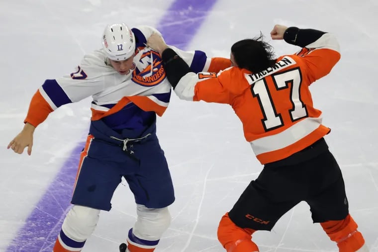 Zack MacEwen (right) of the Flyers and Matt Martin of the Islanders get in a fight during the first period. It was one of two fights in the opening frame Tuesday night.