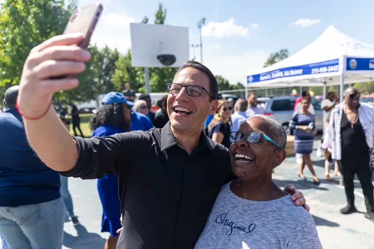 Attorney General Josh Shapiro, the Democratic nominee for Pennsylvania governor, taking a video with Muriel Taylor, of North Philadelphia, at Mander Playground in Philadelphia on Saturday. Shapiro's campaign is trying a variety of tactics to mobilize Black voters ahead of the November election.