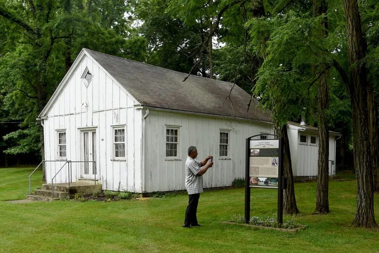 Jacob’s Chapel A.M.E. pastor Terrell Person photographs the interpretive panel outside his congregation's Colemantown Meeting House June 14, 2017. The house was a stop on the Underground Railroad and has been named one of the 10 Most Endangered historic sites in New Jersey.