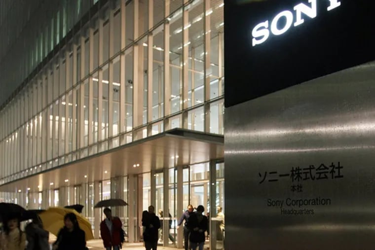 Employees leave the headquarters of Sony Corp. in Tokyo after the electronics company announced yesterday that it was cutting 8,000 of its 185,000 jobs, reducing spending, and shutting plants as it tries to ride out a looming worldwide recession. Senior vice president Naofumi Hara said the job cuts would vary by country, but he did not provide a breakdown.