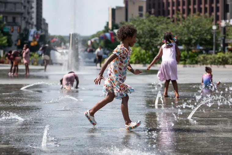 A child runs across the splash pad at Love Park in July during a heat wave in what turned out to be quite a "normal" summer.