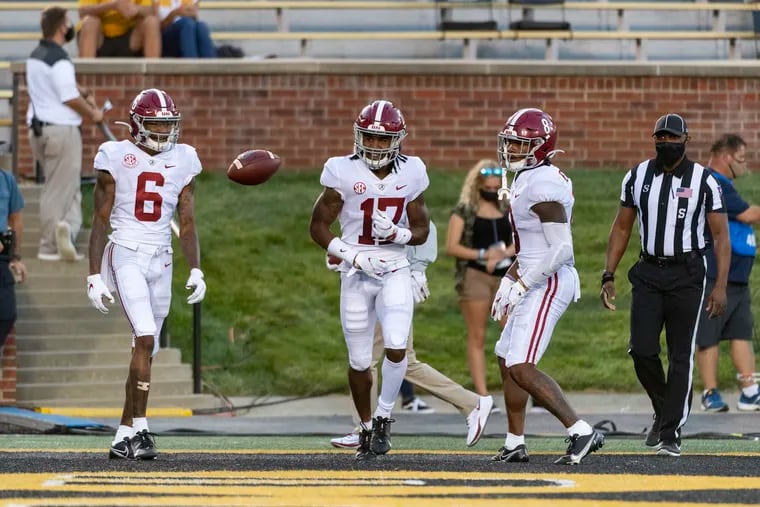 Alabama wide receiver Jaylen Waddle, center, celebrates with teammates DeVonta Smith, left, and John Metchie III, right, after scoring a touchdown during the first quarter of an NCAA college football game against Missouri, Saturday, Sept. 26, 2020, in Columbia, Mo. (AP Photo/L.G. Patterson)