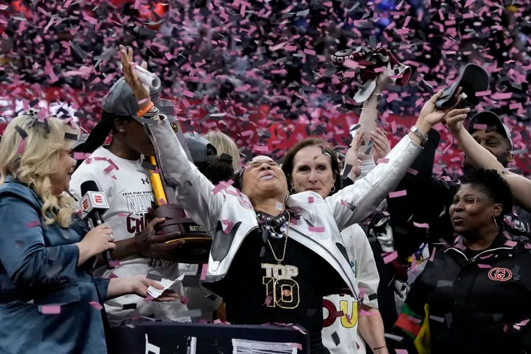 Dawn Staley (center) exults in the confetti after South Carolina won the third national championship of her time as coach.