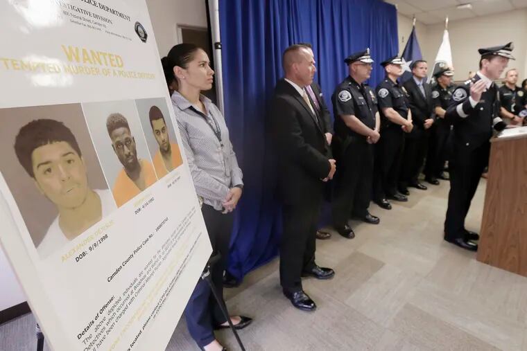 Law enforcement officials and Camden County Police Chief Scott Thomson (right) released photos Friday of the 3 men wanted in connection with the attempted murder of 2 Camden County undercover detective. Juan Figueroa (far right on wanted poster) was arrested Saturday.