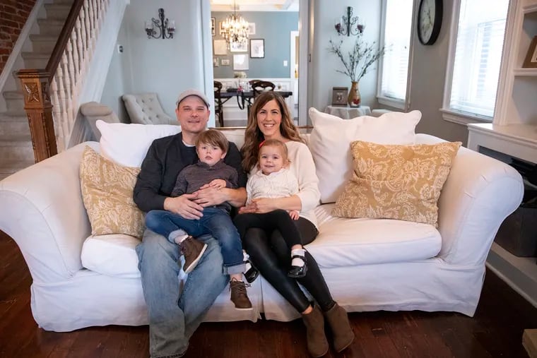 Dan and Katie Mickelson with their two children Noah, 4, and Molly, 2, in the living room of their Bridesburg home.