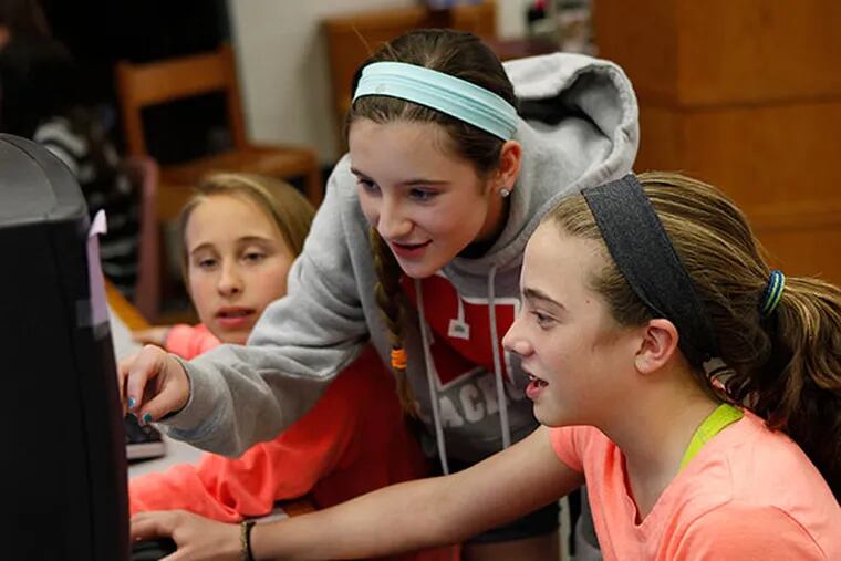 On the computer from left, Claudia Watson, 13, Natalie Naticchia, 13, and Amelia Coty examine a letter written by Samuel Nicholson. The Haddonfield Middle School students were working on a book project on Wednesday, April 22, 2014. ( MICHAEL S. WIRTZ / Staff Photographer )