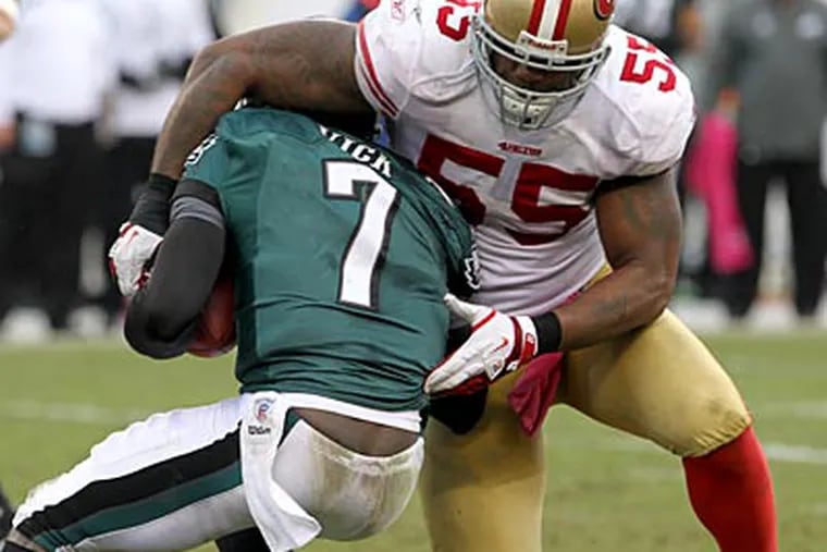 Michael Vick gets sacked by the 49ers' Ahmad Brooks in the third quarter on Sunday. (Charles Fox/Staff Photographer)