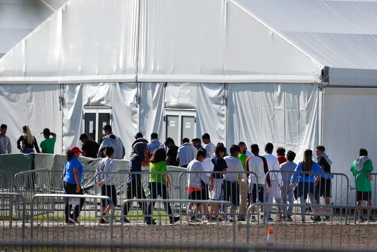 Children line up to enter a tent at the Homestead Temporary Shelter for Unaccompanied Children in Homestead, Fla.