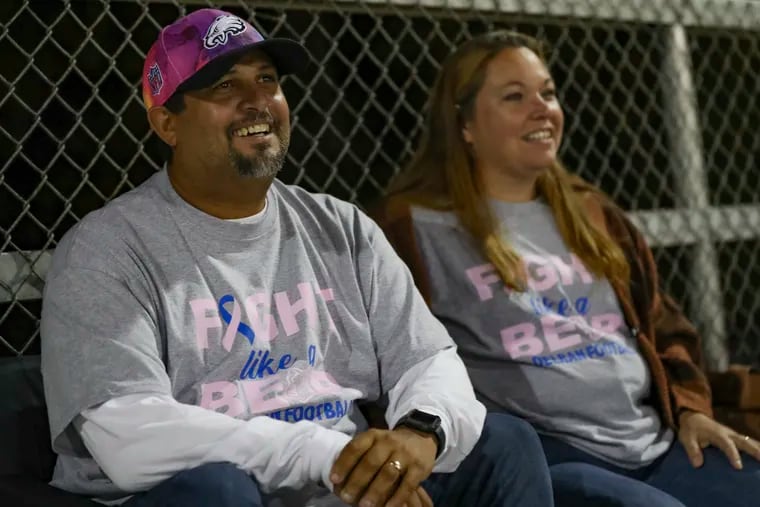 Juan Namnun sitting next to his wife, Lena Namnun, as they watched two of their sons play in a football game at Rancocas Valley Regional High School in Mt. Holly on Oct. 7.