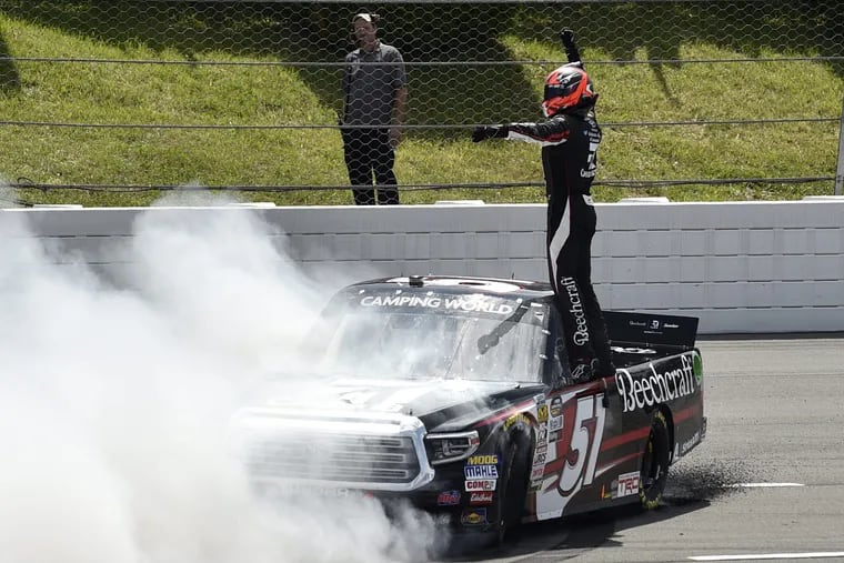 Kyle Busch celebrates after winning a NASCAR Truck Series auto race, Saturday, July 28, 2018, in Long Pond, Pa. (AP Photo/Derik Hamilton)
