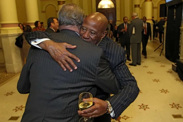 Bernard Watson (right), who with then-Mayor Ed Rendell got the Avenue of the Arts in motion, hugs Thomas McGill.