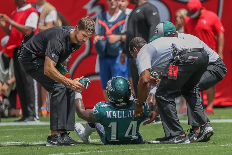 Eagles medical personal help Eagles wide receiver Mike Wallace up off the turf in the first quarter of the game against Tampa Bay on Sunday September 16, 2018. MICHAEL BRYANT / Staff Photographer