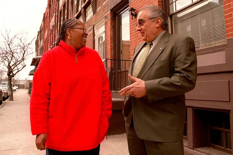 Judge Cermele talks with Judy Daniels in 2001 after her house on West Thompson Street was rehabilitated as part of the Girard College housing initiative.